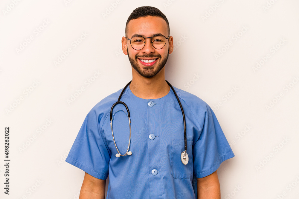Young hispanic nurse man isolated on white background happy, smiling and cheerful. Young hispanic nurse man isolated on white background happy, smiling and cheerful.