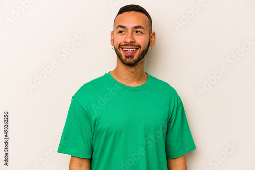 Young hispanic man isolated on white background relaxed and happy laughing, neck stretched showing teeth.