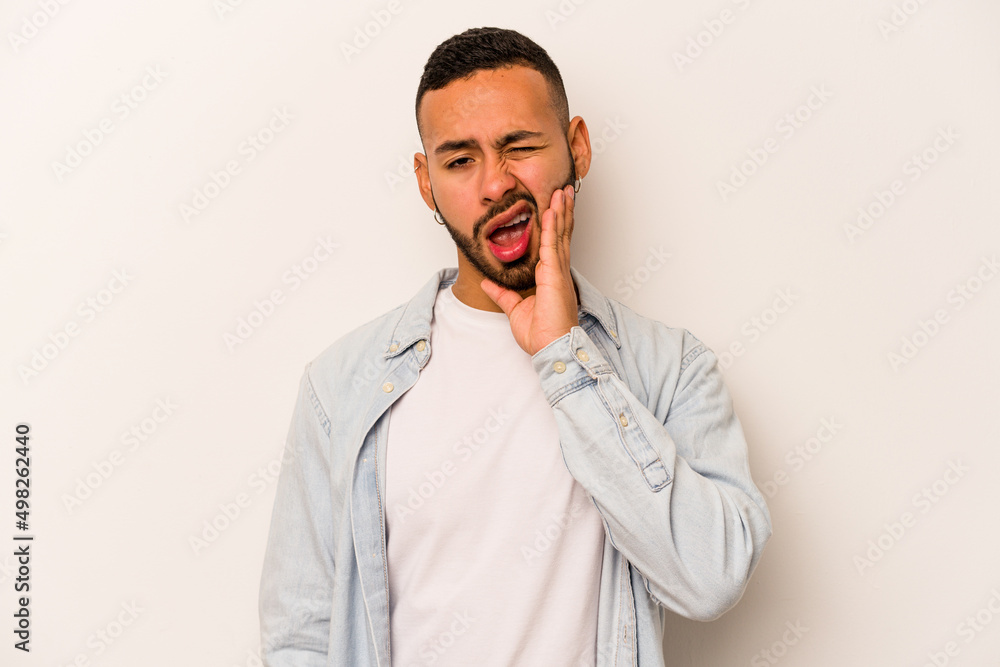 Young hispanic man isolated on white background having a strong teeth pain, molar ache. Young hispanic man isolated on white background having a strong teeth pain, molar ache.
