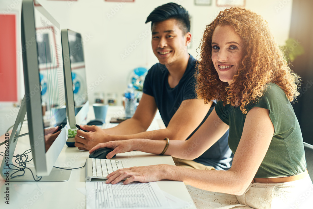 Were chasing success. Cropped portrait of two young creative businesspeople working on a computer in their office. Were chasing success. Cropped portrait of two young creative businesspeople working on a computer in their office.