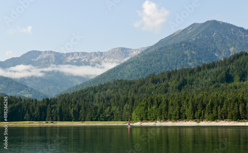 Fototapeta Naklejka Na Ścianę i Meble -  Standup paddling on bavarian mountain lake, Sylvensteinsteicher