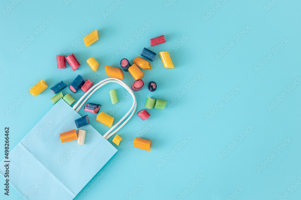 Flat lay, paper bag and chewing bags on a blue background. Flat lay, paper bag and chewing bags on a blue background.