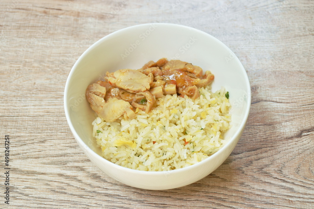 fried rice with egg topping chicken in Korean sauce on bowl fried rice with egg topping chicken in Korean sauce on bowl