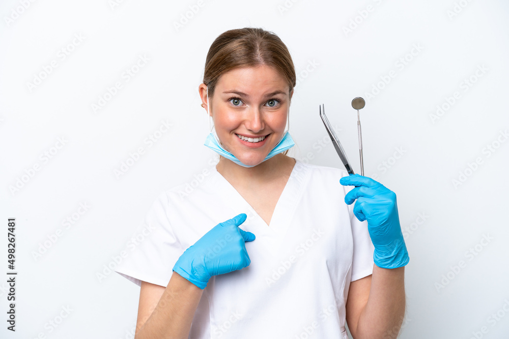 Dentist caucasian woman holding tools isolated on white background with surprise facial expression Dentist caucasian woman holding tools isolated on white background with surprise facial expression