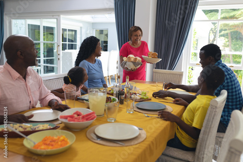 African american having lunch together at dining table on thanksgiving day