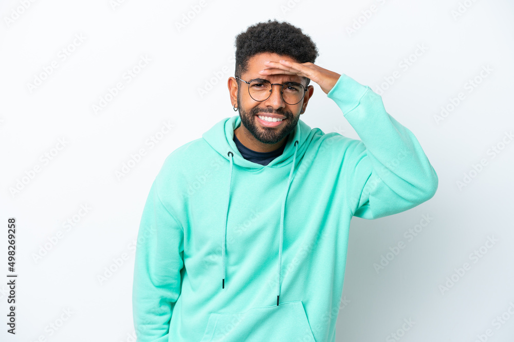 Fototapeta premium Young Brazilian man isolated on white background looking far away with hand to look something