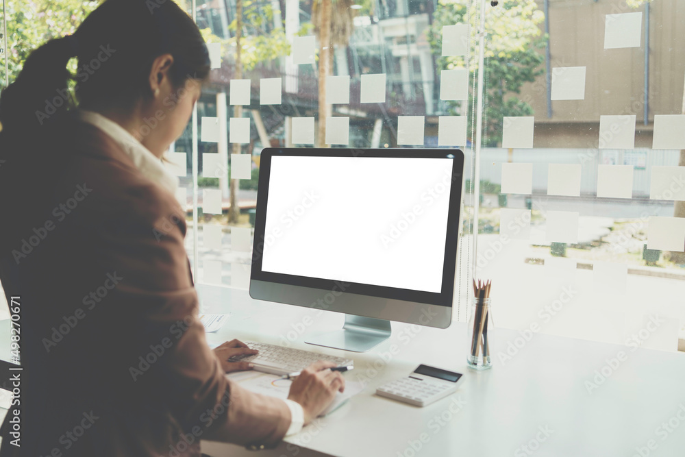 Young woman work on laptop with blank display screen with mockup copy space. Modern home living room interior design. Work at office concept. Young woman work on laptop with blank display screen with mockup copy space. Modern home living room interior design. Work at office concept.