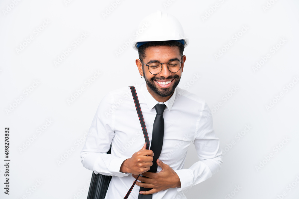 Young architect Brazilian man with helmet and holding blueprints isolated on white background smiling a lot Young architect Brazilian man with helmet and holding blueprints isolated on white background smiling a lot