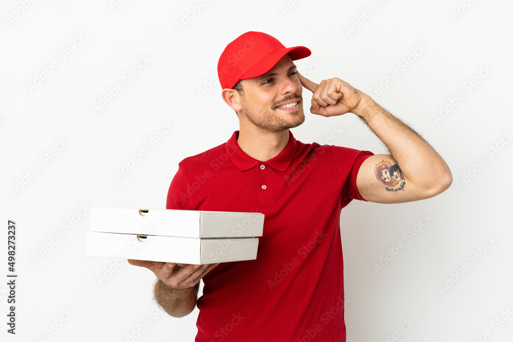 pizza delivery man with work uniform picking up pizza boxes over isolated white wall having doubts and thinking pizza delivery man with work uniform picking up pizza boxes over isolated white wall having doubts and thinking