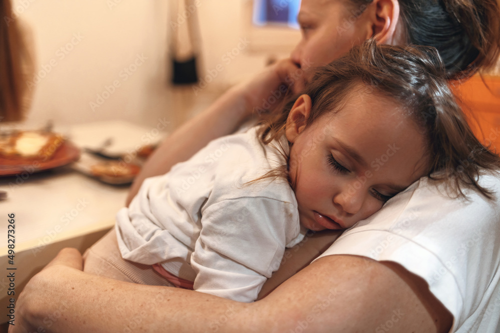 Mother holding her sleeping baby girl at home. Mother putting her baby to sleep. Mother embracing her baby girl while sleeping, lifestyle concept. Mother holding her sleeping baby girl at home. Mother putting her baby to sleep. Mother embracing her baby girl while sleeping, lifestyle concept.