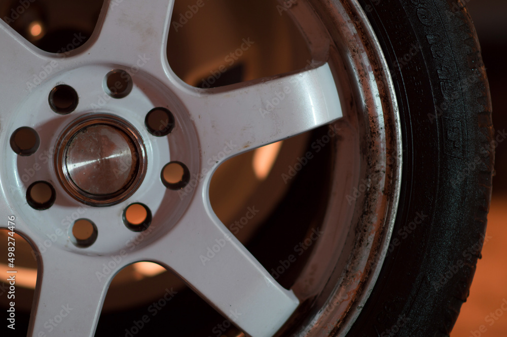 old white car rims in an old garage in the dark old white car rims in an old garage in the dark