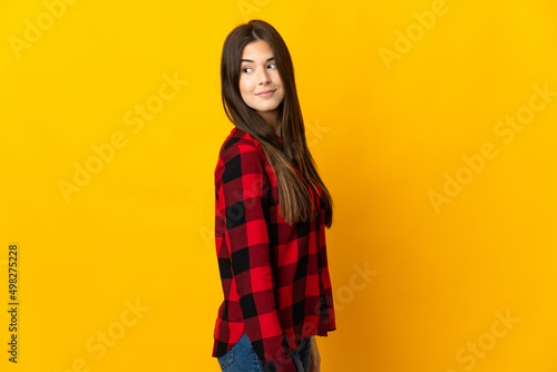 Teenager Brazilian girl isolated on yellow background . Portrait © luismolinero