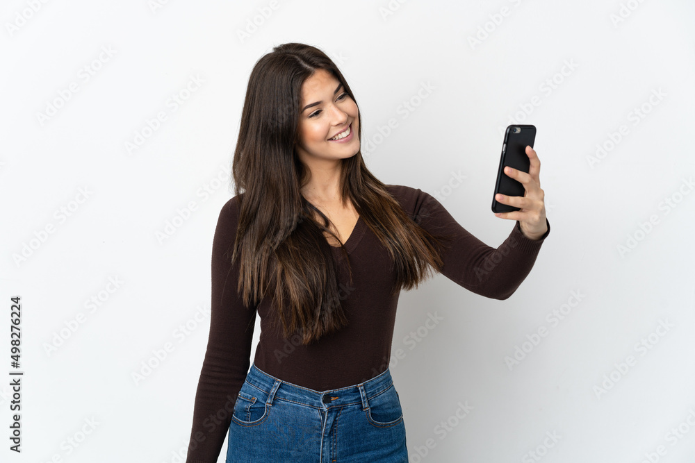 Teenager Brazilian girl isolated on white background making a selfie Teenager Brazilian girl isolated on white background making a selfie