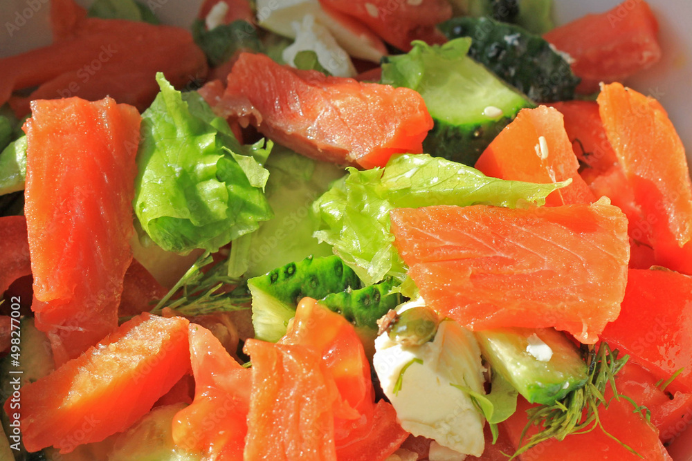 Delicious fresh sliced vegetable salad with salmon, healthy food close up Delicious fresh sliced vegetable salad with salmon, healthy food close up