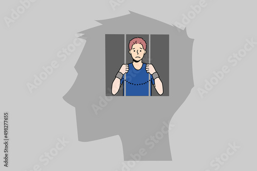 Man in jail inside human head suffer from freedom of thoughts or rights. Unhappy imprisoned male locked in mind have life restrictions and bans. Brain prison. Vector illustration. 