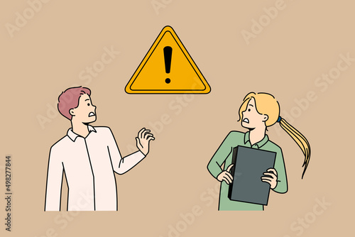 Scared businesspeople frustrated with exclamation warning sign. Anxious woman and man afraid of caution symbol aware of business risk or problem. Failure prevention concept. Vector illustration.