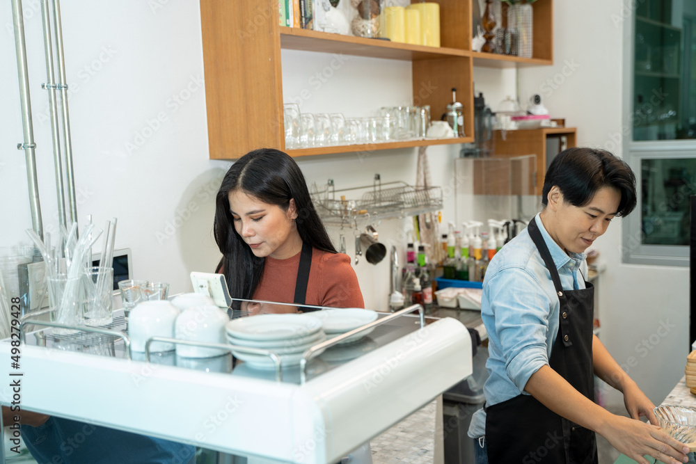 Barista using a coffee maker to coffee,Cafe worker making a coffee,Cafe owner in apron making coffee.