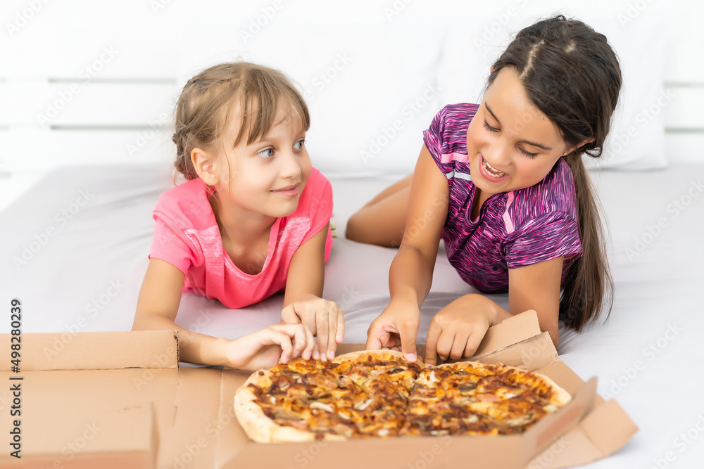 Attractive little girls posing with pizza boxes