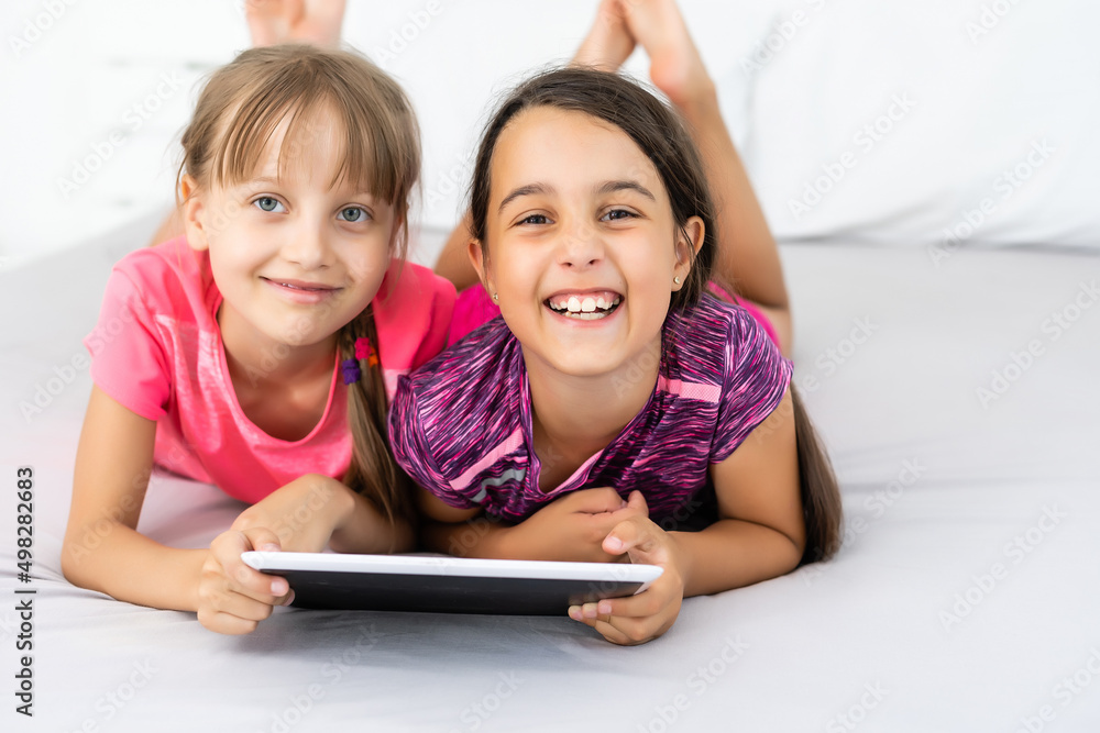 Little girls using tablet computer as art board - painting together Little girls using tablet computer as art board - painting together