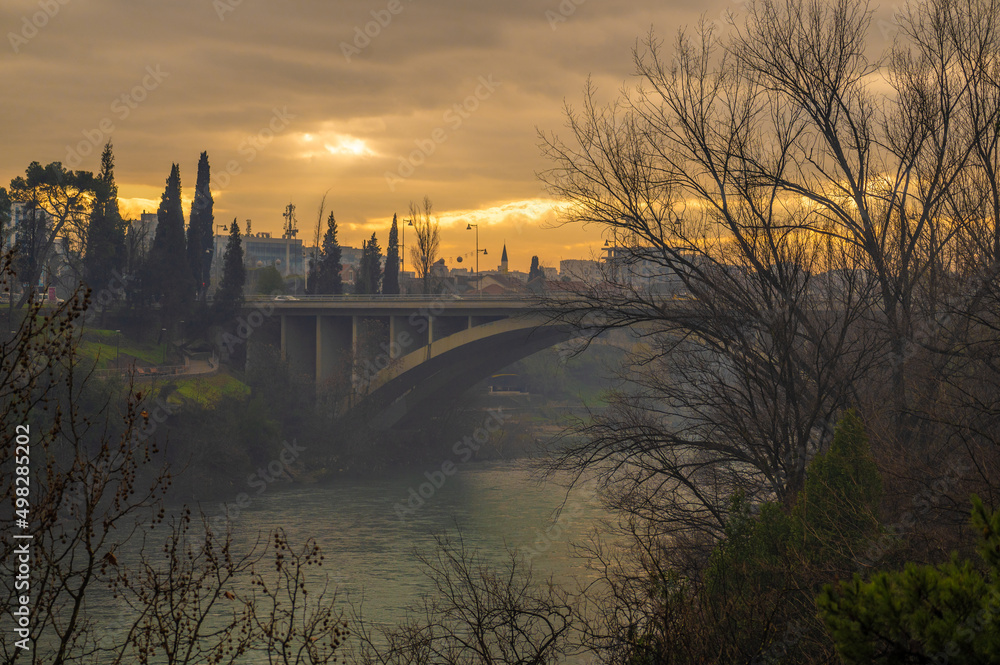 Obraz na płótnie Blazo Jovanovic Bridge over the river Moraca in Podgorica, capital of Montenegro. evening, winter, sunset, dawn w salonie