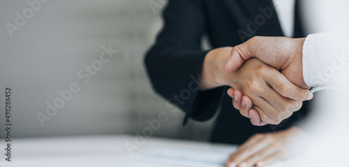 Картината върху платно Close-up two business men holding hands, Two businessmen are agreeing on business together and shaking hands after a successful negotiation