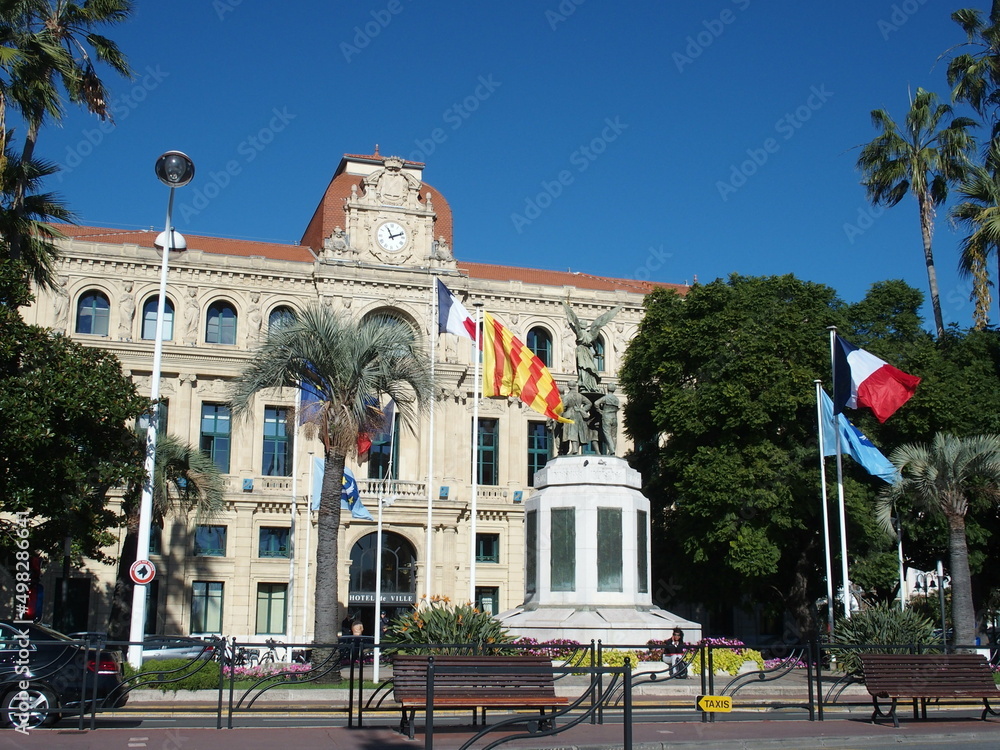 The City Hall of Cannes, France, with a war memorial in the foreground