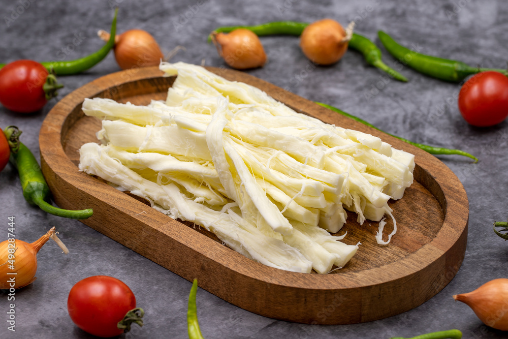 Cecil cheese or String cheese on a dark floor. Delicious assortment of cheeses. close up Cecil cheese or String cheese on a dark floor. Delicious assortment of cheeses. close up