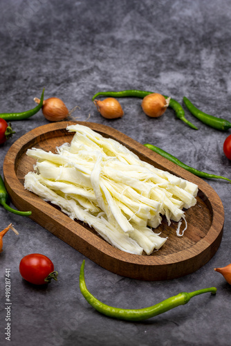 Cecil cheese or String cheese on a dark floor. Delicious assortment of cheeses. close up