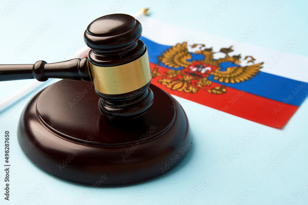 lag of Russia and judge gavel on blue background