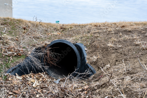 HDPE drainage culvert under a road entrance. Pipe is used to convey stormwater between ditches. photo