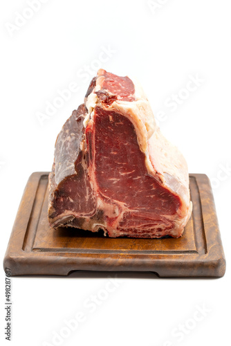 Dry-aged Raw T-bone or porterhouse beef meat Steak with tomatoes and peppers. white background. Yakın çekim
