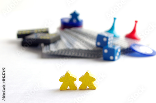 Wallpaper Mural two yellow wooden meeple game pieces in front of blurry game parts Torontodigital.ca