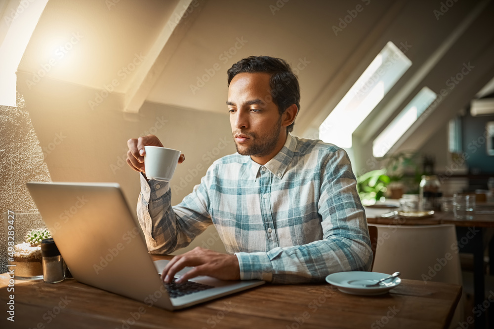 Nothing goes together like free internet and good coffee. Shot of a young entrepreneur using his laptop in a coffee shop. Nothing goes together like free internet and good coffee. Shot of a young entrepreneur using his laptop in a coffee shop.