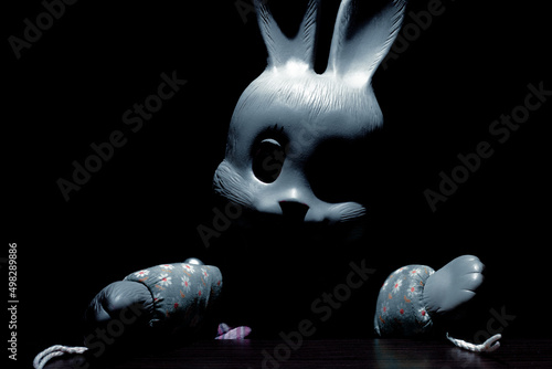 Frightening bunny with black empty eyes in the dark photo