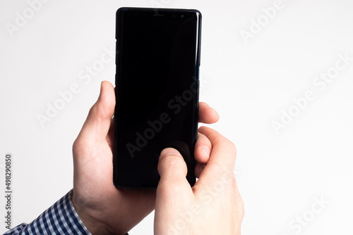 Hands holding a smartphone....