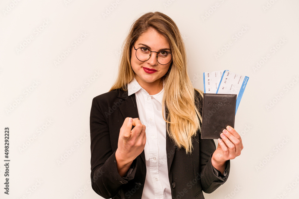 Young business caucasian woman holding a passport isolated on white background pointing with finger at you as if inviting come closer. Young business caucasian woman holding a passport isolated on white background pointing with finger at you as if inviting come closer.