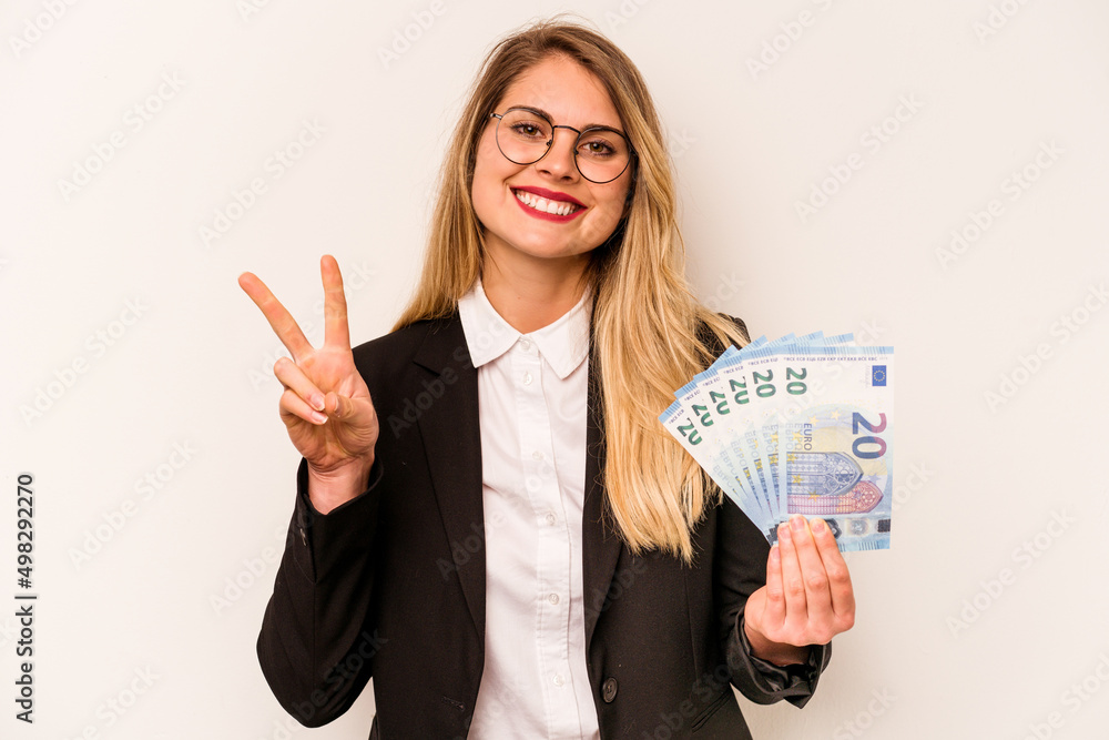 Young business caucasian woman holding a banknotes isolated on white background showing number two with fingers. Young business caucasian woman holding a banknotes isolated on white background showing number two with fingers.