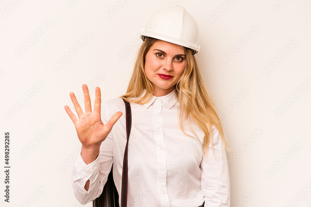 Young architect woman with helmet and holding blueprints isolated on white background smiling cheerful showing number five with fingers.