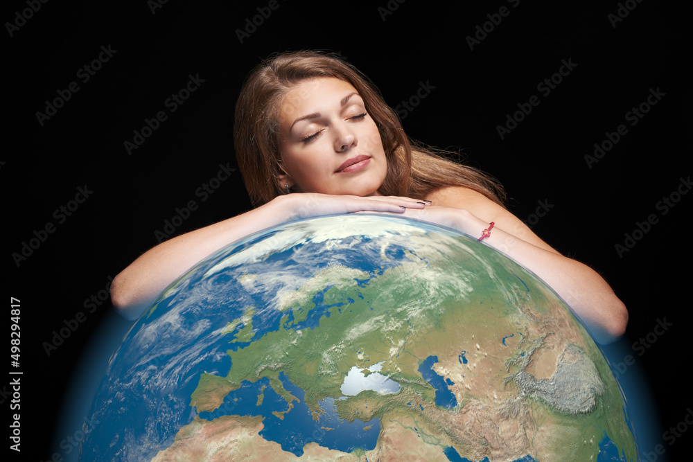 Dreaming beautiful woman hugging earth globe in her hands with closed eyes Dreaming beautiful woman hugging earth globe in her hands with closed eyes