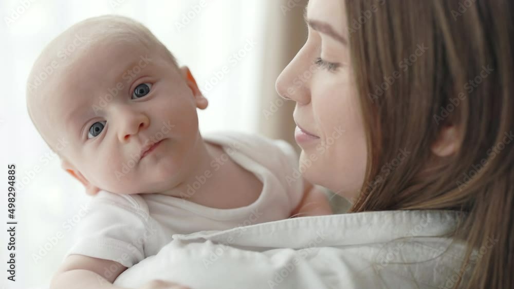 Caucasian woman holding on hands her newborn son Caucasian woman holding on hands her newborn son