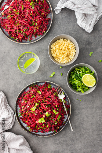 Vegetarian salad with couscous and grated beets, parsley and dill and green onions, light healthy tasty salad photo