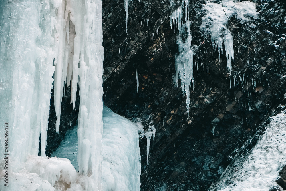 Winter waterfall with frozen water and snow Winter waterfall with frozen water and snow