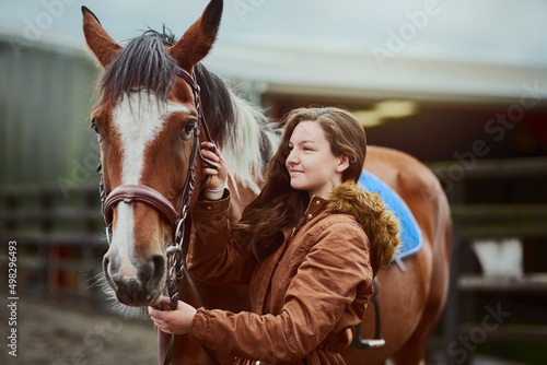 Her pony, her first love. Shot of a teenage girl standing next to her pony on a farm. © AS/peopleimages.com