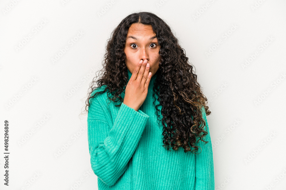 Young hispanic woman isolated on white background shocked, covering mouth with hands, anxious to discover something new.