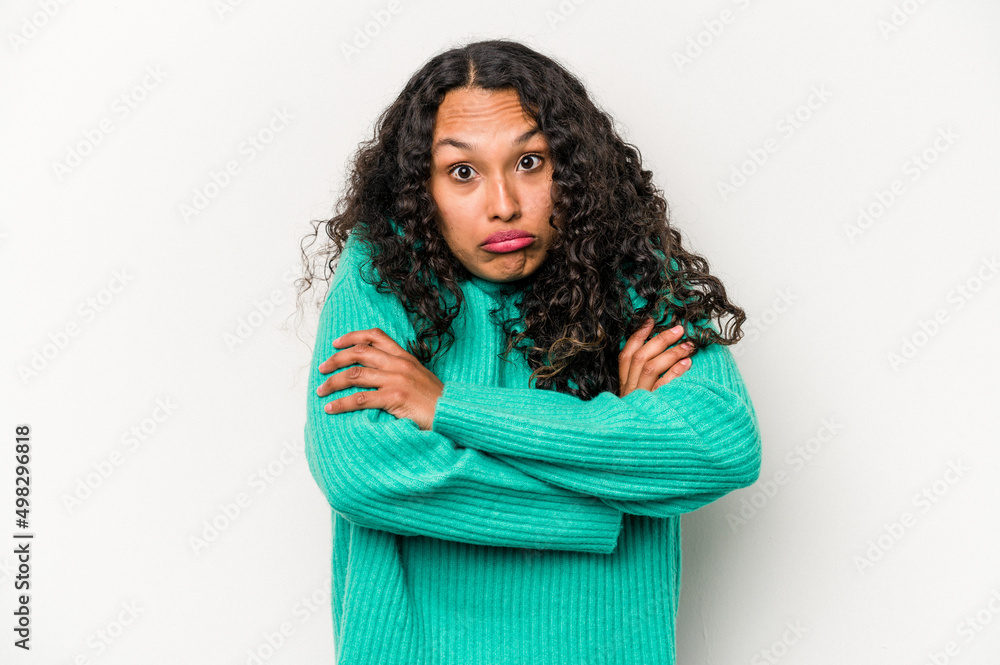 Young hispanic woman isolated on white background shrugs shoulders and open eyes confused. Young hispanic woman isolated on white background shrugs shoulders and open eyes confused.