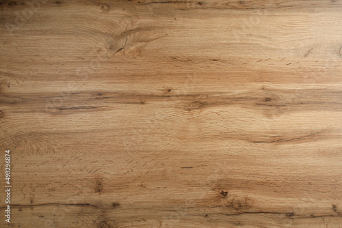 Wooden background texture. Light brown surface of old knotty wood with a natural color