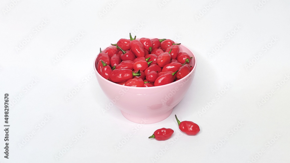 Red peppers in the bowl with white background. Space for text Red peppers in the bowl with white background. Space for text