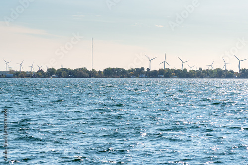Wind farm on a lake island on a sunny autumn morning