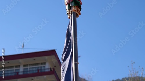 Slow motion shot of Colorful Buddhist Tibetan prayer flag against the blue sky at Pangan Nyingma Monastery in Patlikuhal village near Manali, Himachal Pradesh, India