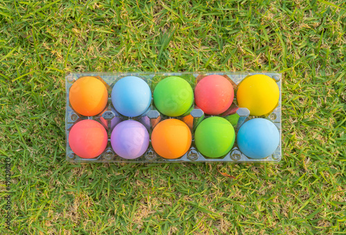 Colorful easter eggs on natural green grass background. Food decoration on holiday.